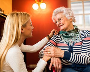 caregiver comforting senior woman