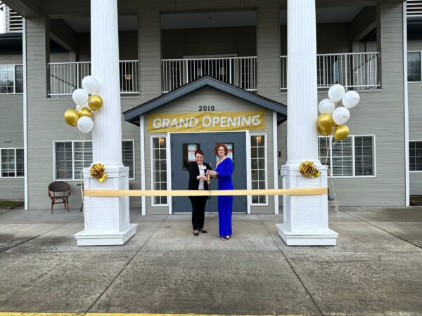 photo of two women cutting ribbon in front of building for contact centralia point page 