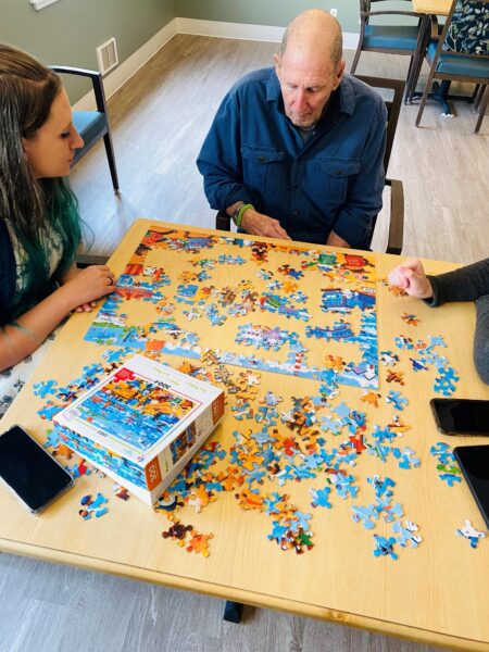 Puzzling is a Life Enrichment activity with memory care residents